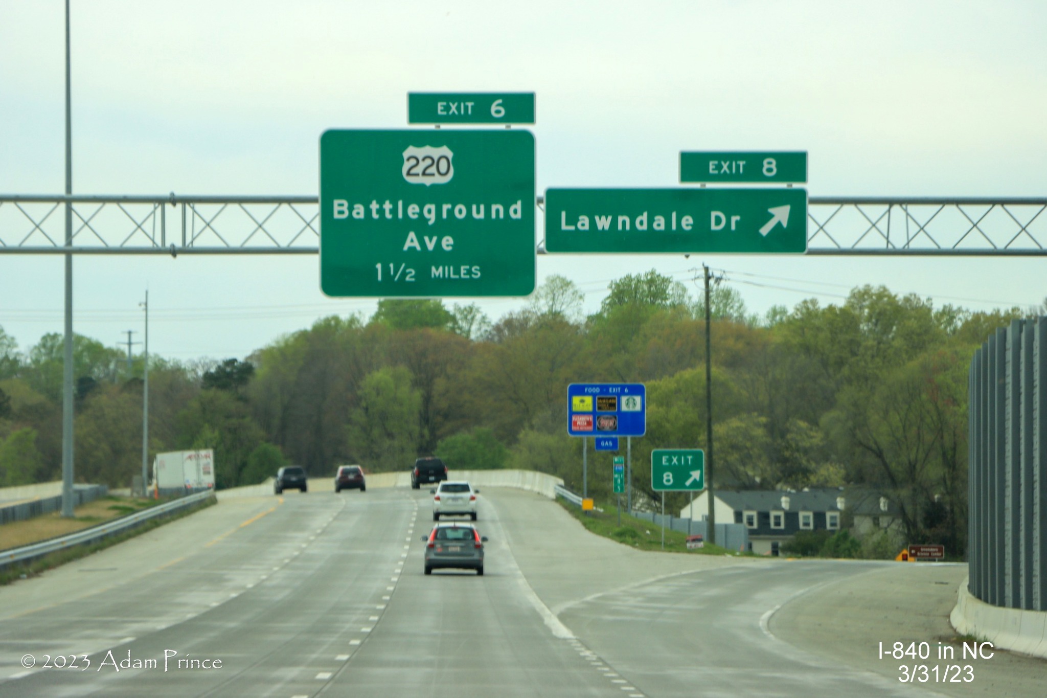 Image of 1 1/2 Miles advance sign for US 220/Battleground Avenue at ramp for Lawndale Drive on 
             I-840 West/Greensboro Urban Loop, Adam Prince, March 2023