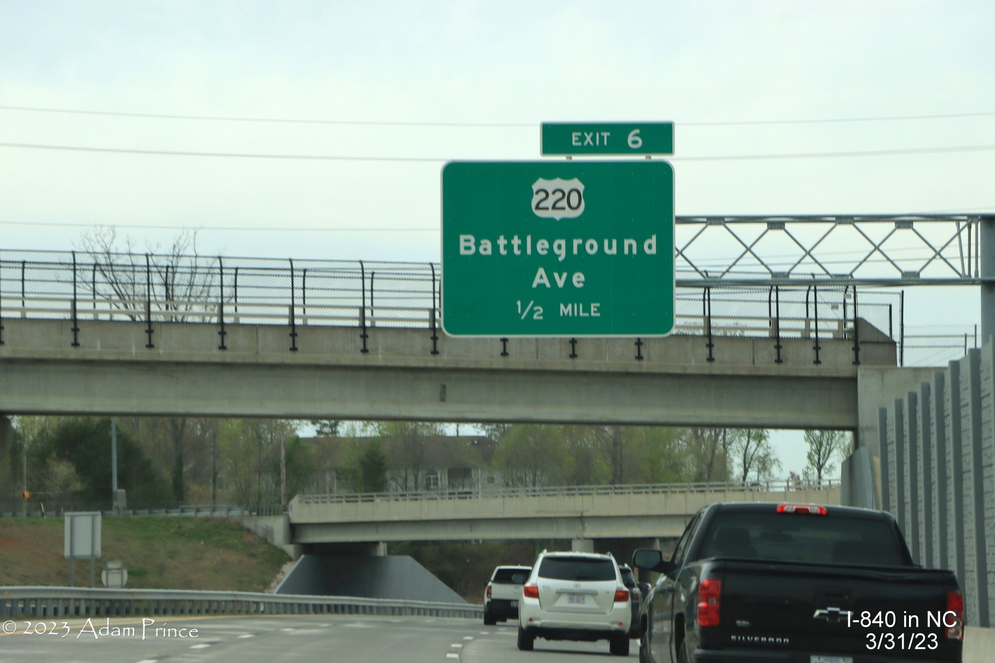 Image of 1/2 Mile advance overhead sign for US 220/Battleground Avenue exit on I-840 West/Greensboro Urban Loop,
             Adam Prince,  March 2023