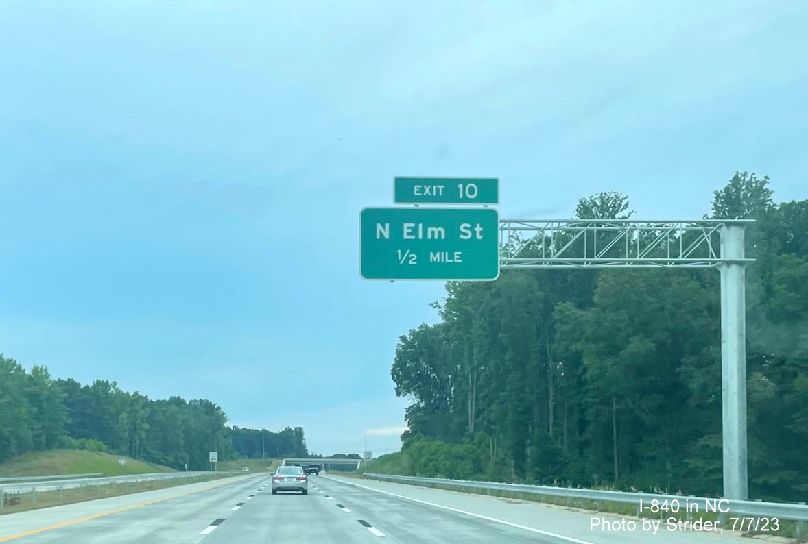 Image of newly placed 1/2 mile advance overhead sign for Yanceyville Street exit on I-840/Greensboro 
         Loop West, photo by Strider, July 2023