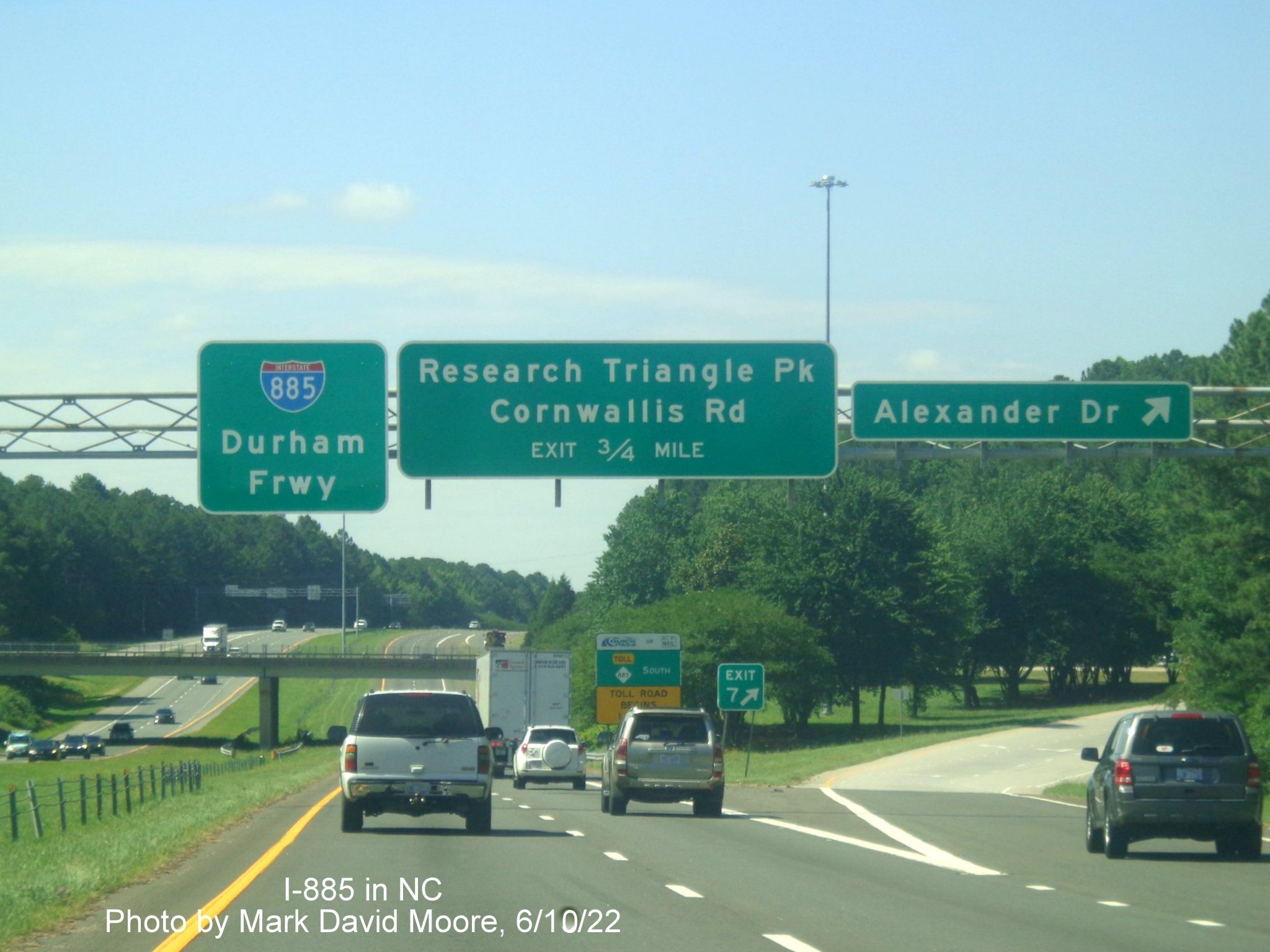 Image of overhead pull through sign with I-885 shield replacing NC 147
         on the Durham Freeway south at Alexander Drive, by Mark David Moore June 2022