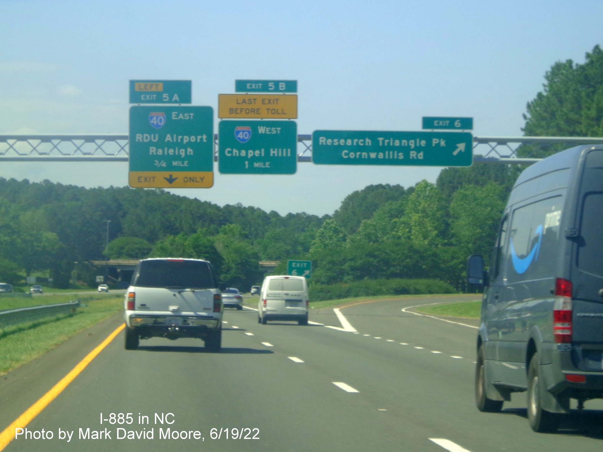 Image of overhead advance signage for I-40 exits, no longer with NC 54,
         on the Durham Freeway south at Cornwallis Road, by Mark David Moore June 2022