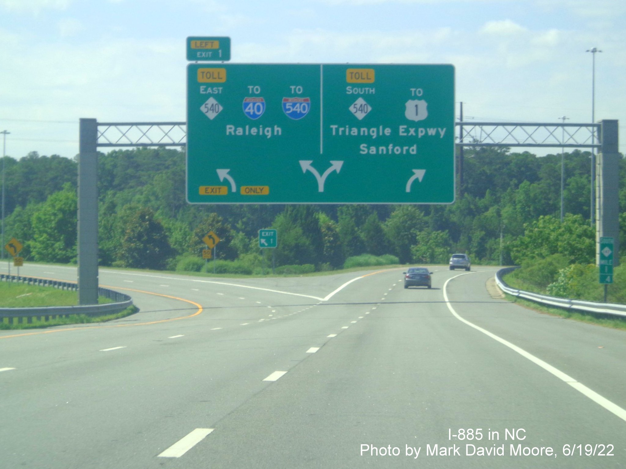 Image of overhead arrow-per-lane sign at the end of NC 885 at NC 540/
         Triangle Expressway in Wake County, by Mark David Moore June 2022